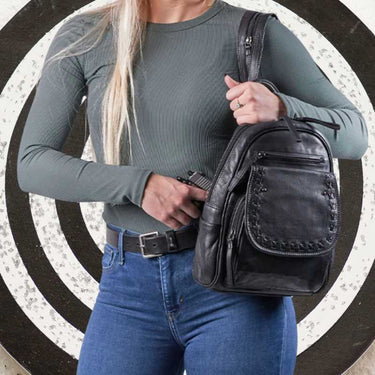 female-deploying-black-cognac-daisy-lether-conceal-carry-backpack